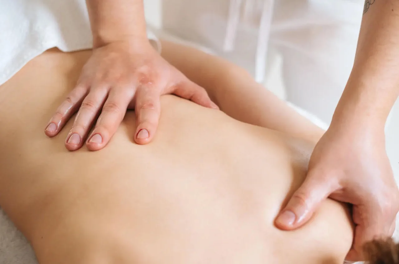 Aromatherapy massage with warm essential oil on the back at G Spa Massage Cypress