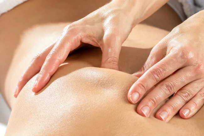 Deep tissue massage with firm focused pressure on the shoulder at G Spa Massage Cypress